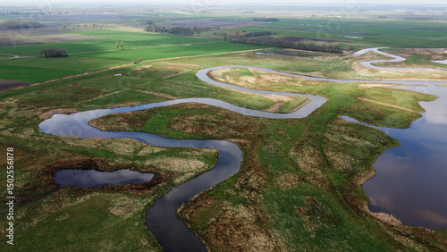 Rural river landscape nature aerial drone photo grass land and body of water stream. Dutch natural scene.