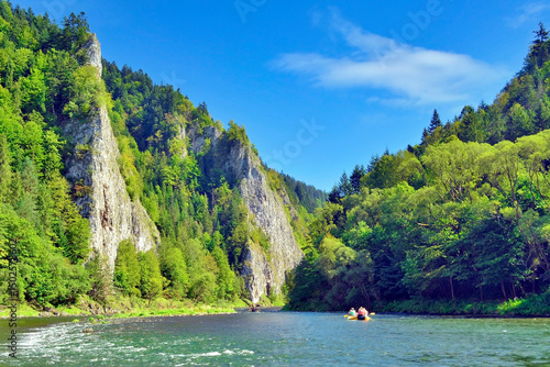 Fototapeta Naklejka Na Ścianę i Meble -  Rafting on the Dunajec river in the Pieniny National Park at summer sunny day. It is a popular tourist attraction in Pieniny mountains, Poland
