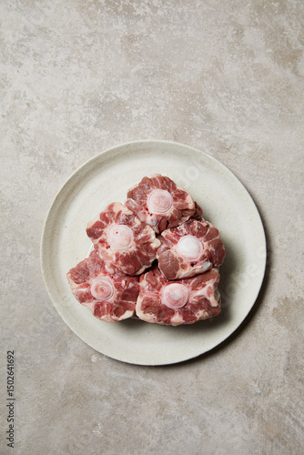 Fresh oxtail pieces arranged on a plate