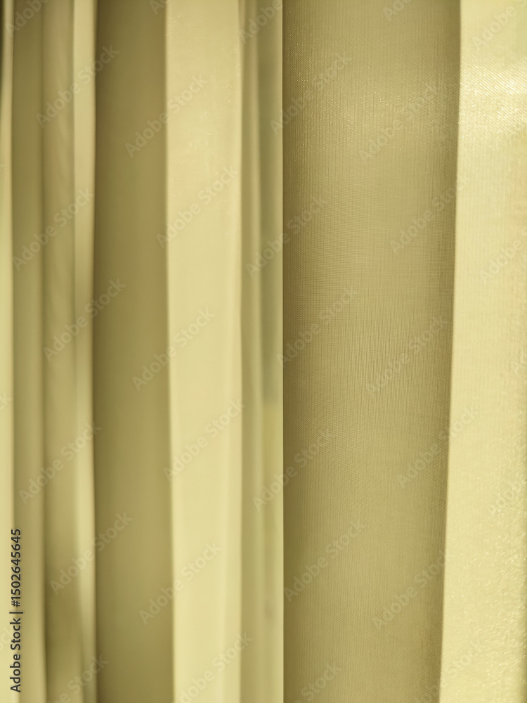 Obraz premium Net Curtain Background. Light, translucent yellow curtain on window is illuminated by sun. Full frame. Copy space. Close-up.