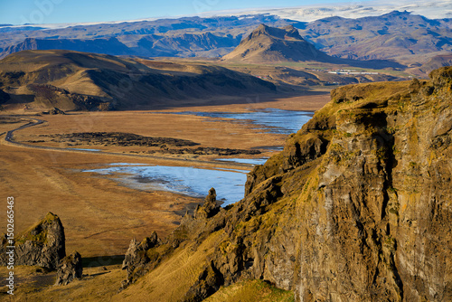 A natural view of the rocky cliffs on the coast of Dyrholaey Vik in Iceland , Travel destination of traveller.