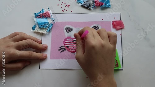 hobby handcraft diamond mosaic at the stage of gluing crystals