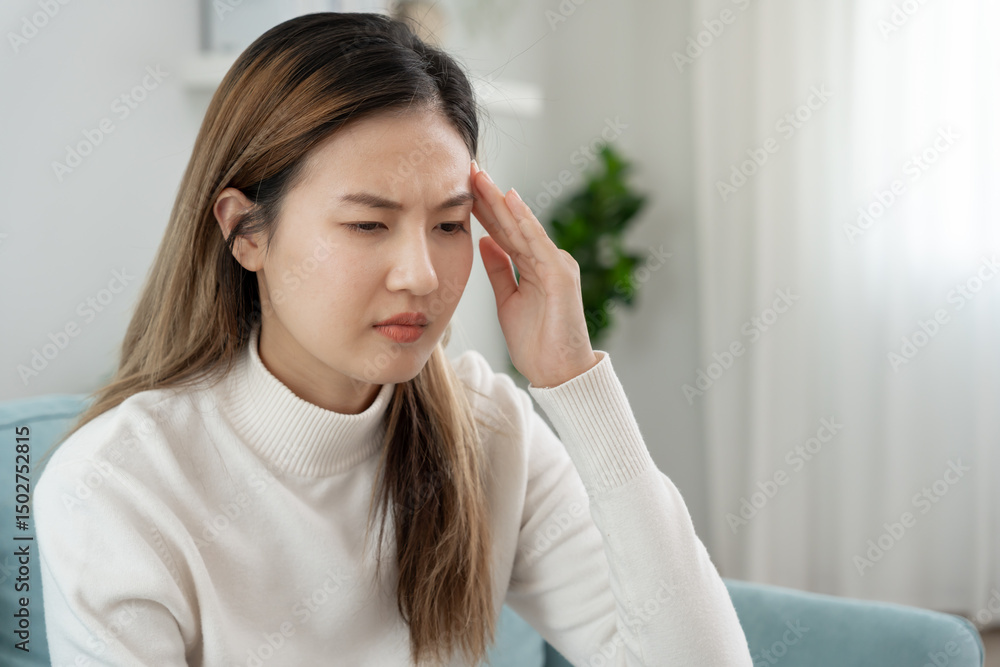 Headache, female having migraine pain, bad health, Asian woman feeling stress and headache, Office syndrome, sad tired touching forehead having migraine or depression, irritated girl, sadness grief. Headache, female having migraine pain, bad health, Asian woman feeling stress and headache, Office syndrome, sad tired touching forehead having migraine or depression, irritated girl, sadness grief.