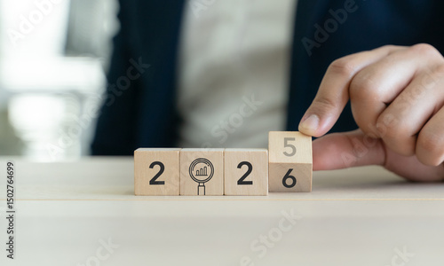 Trend 2026 concept. Upcoming trends and business insight for the year 2026. Hand rotates a wooden block to reveal the year 2026. Foresight, innovation and strategic business planning for the future.
