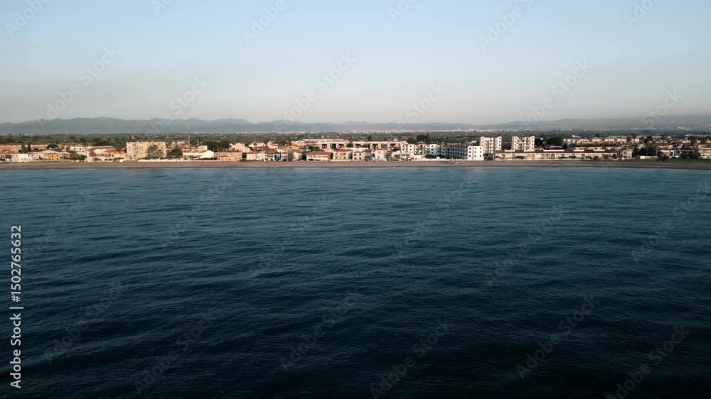 Drone flight over the city embankment along the sea and the beach.
with a view of the Town, sunrise lighting parallel to the beach flight Drone flight over the city embankment along the sea and the beach.
with a view of the Town, sunrise lighting parallel to the beach flight