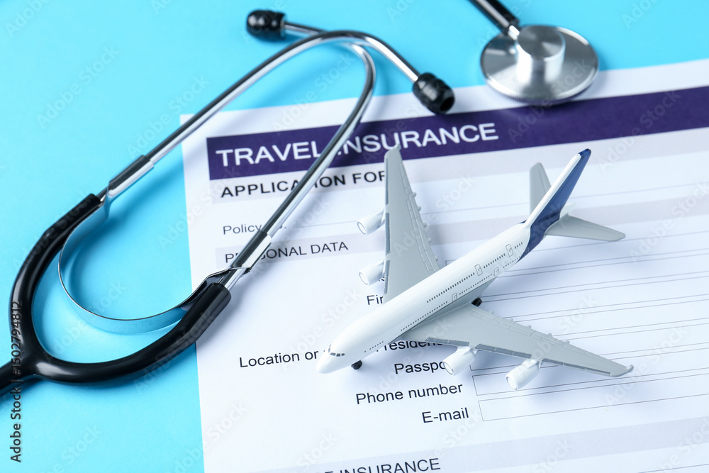 Medical tourism. Travel insurance application form, stethoscope and plane model on light blue background, closeup Medical tourism. Travel insurance application form, stethoscope and plane model on light blue background, closeup
