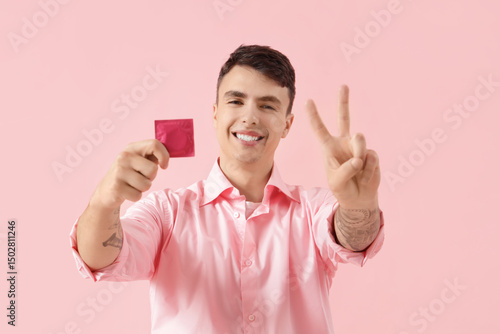 Young man showing condom an...