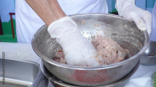 Close-up of Chef Mixing Ground Pork in Bowl During Food Preparation