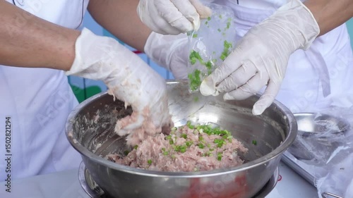 Close-up of Chef Mixing Ground Pork in Bowl During Food Preparation