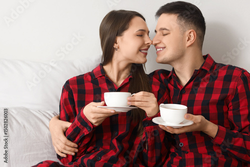 Young couple with cups of c...