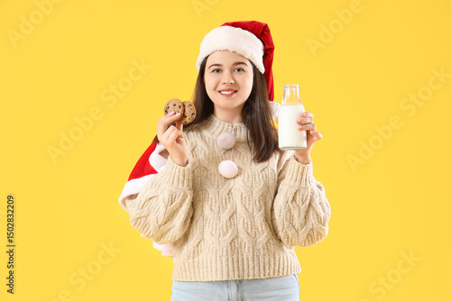 Young woman in Santa hat wi...