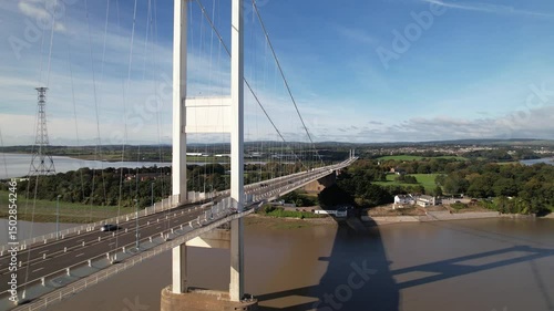 large cable-stayer bridge spanning wide river. Shadow on water surface. Severn Bridge, Wales, UK