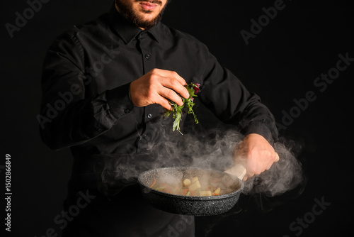 Male chef frying vegetables...
