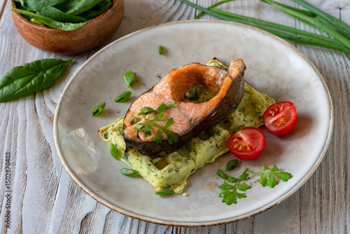 Trout on potato waffle with spinach.