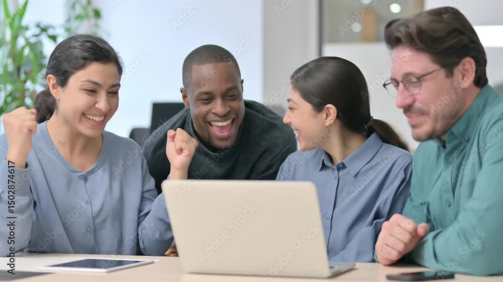 Diverse Team Celebrating Success Looking at Laptop Achieving Goals and Collaboration Diverse Team Celebrating Success Looking at Laptop Achieving Goals and Collaboration