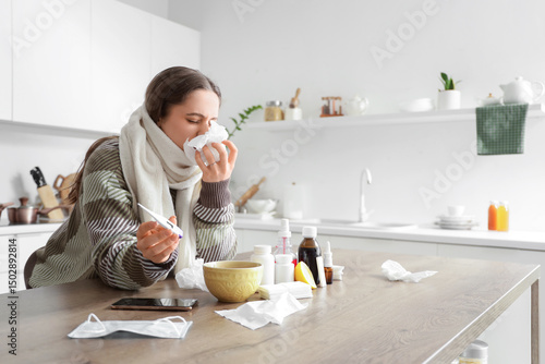 Sick young woman with tissu...