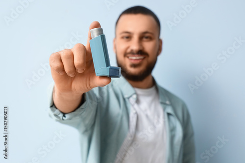 Young man with inhaler on l...
