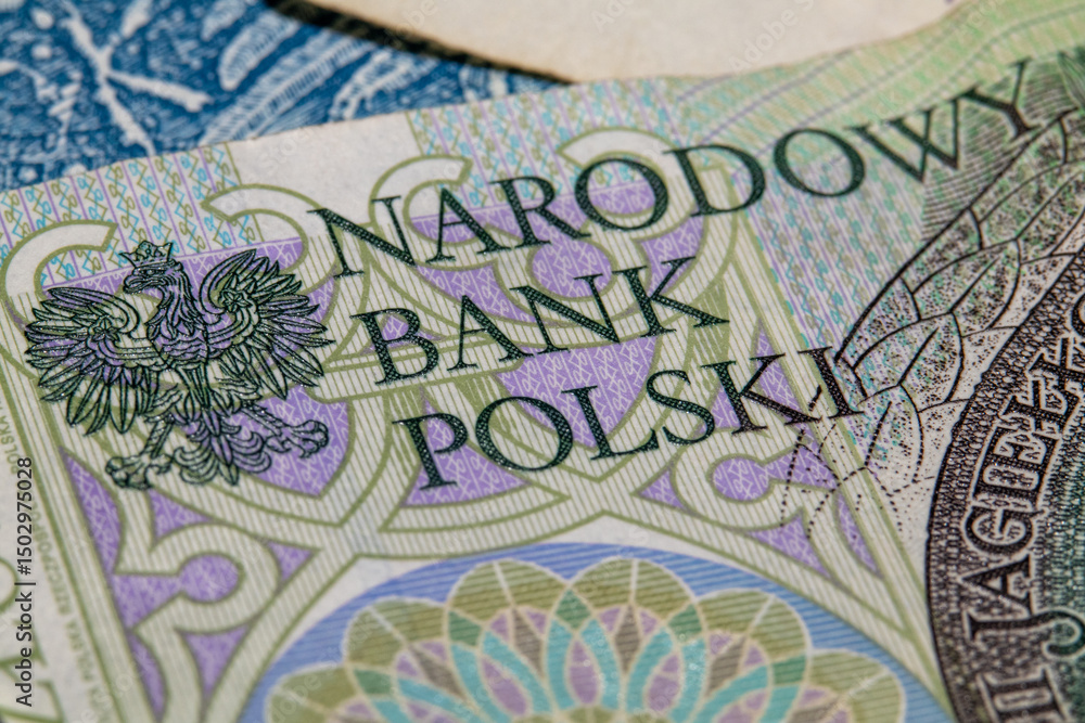 Fototapeta premium Close-up of Polish banknote detail showing the national emblem and Narodowy Bank Polski text.
