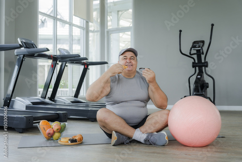 Photography Fat man sits on a fattening diet in the gym