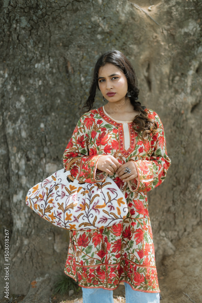 Women posing for a brand Kaar Kash wearing red chinar kurti with kashmir crewal bag Women posing for a brand Kaar Kash wearing red chinar kurti with kashmir crewal bag