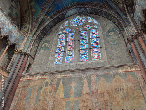 Interior of the Basilica of Saint Francis of Assisi with colorful frescoes by Giotto on the walls and ceiling. Italy.
