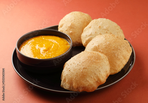 Indian Food - Aamras is a sweet dish made from the pulp of the Alphonso mango fruit. Served with hot puri/poori. Sweet Mango puree garnished with Kashmiri Saffron. Aam Ras Puri OR Alphonso Mango