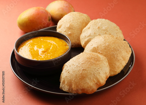 Indian Food - Aamras is a sweet dish made from the pulp of the Alphonso mango fruit. Served with hot puri/poori. Sweet Mango puree garnished with Kashmiri Saffron. Aam Ras Puri OR Alphonso Mango