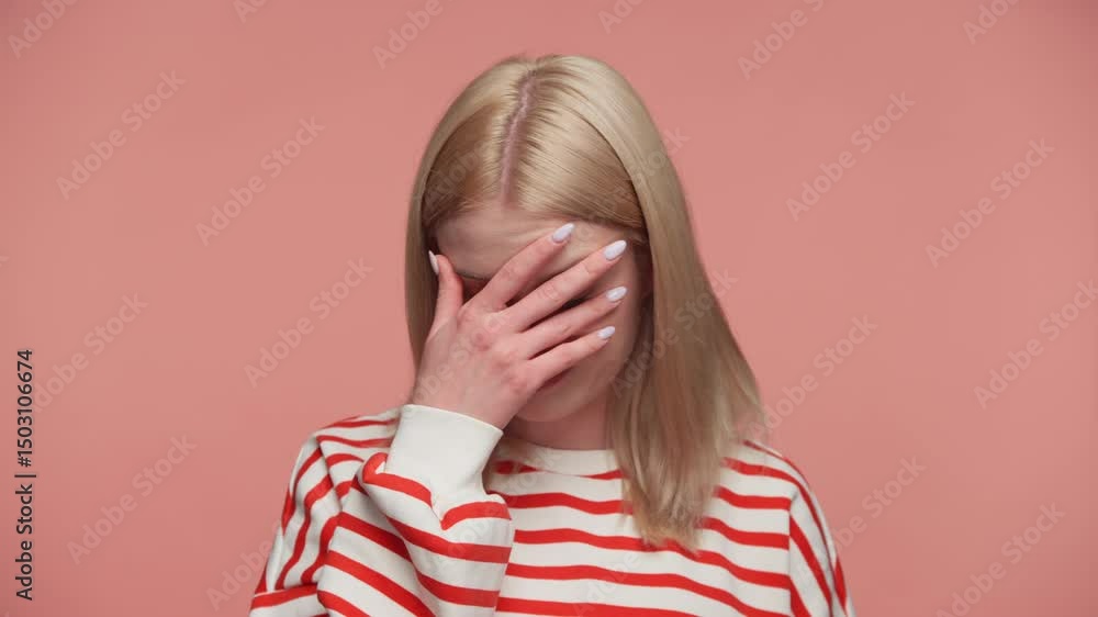 Frustrated woman doing facepalm gesture on pink background Frustrated woman doing facepalm gesture on pink background