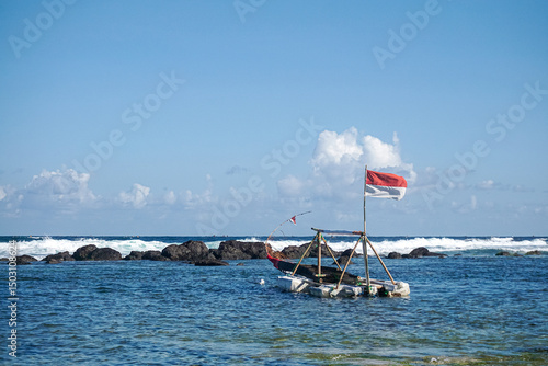 Wallpaper Mural Traditional Raft Boat with Red and White on Clear Blue Ocean at Pidakan beach Pacitan East Java Indonesia Torontodigital.ca