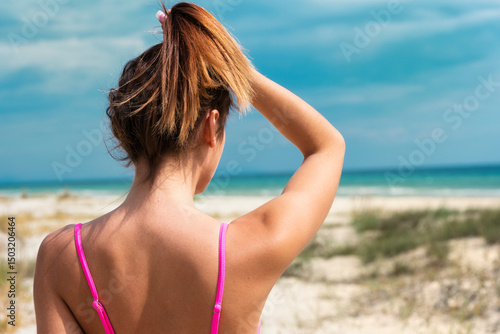 Head of a woman holding the hair