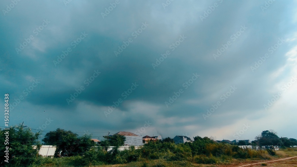 Dramatic Dark Clouds Gathering Over a Suburban Landscape Dramatic Dark Clouds Gathering Over a Suburban Landscape