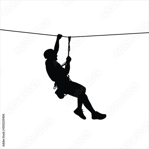Silhouette of a person zipping lining through the air wearing protective gear