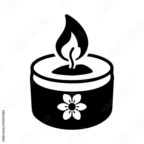 Black and White Tealight Candle with Floral Design and Burning Flame