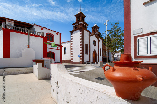 View of the church de San Matías in Artesana with red flower pot in foreground, Gran Canaria, Spain