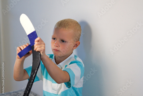 Canvas Print Boy taping his ice hockey stick