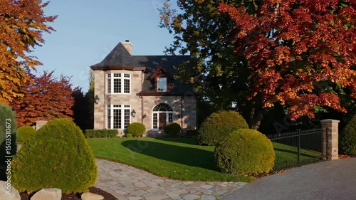 Charming autumn house surrounded by vibrant fall foliage and manicured landscape