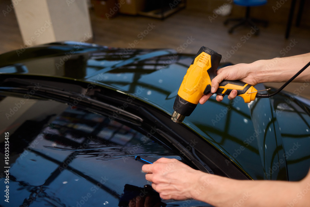 The Professional Windshield Tinting Process Conducted in a Modern Auto Showroom Environment The Professional Windshield Tinting Process Conducted in a Modern Auto Showroom Environment