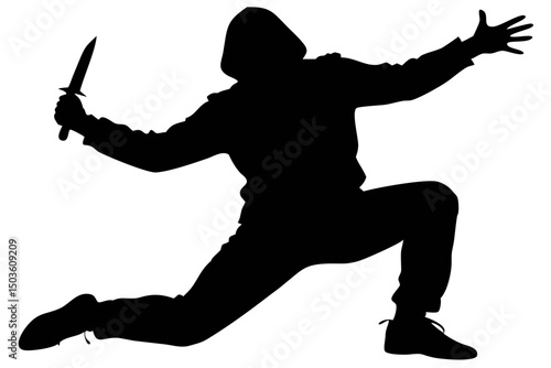 Silhouette of a Man in Hoodie Holding a Knife in an Action Pose at Night