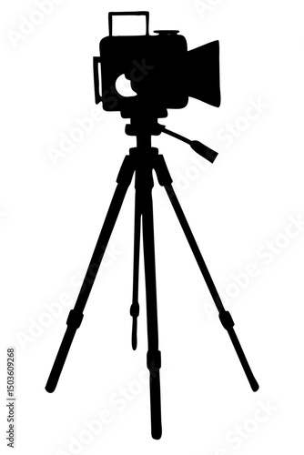 Silhouette of an Old Fashioned Camera on a Tripod Set Against a Light Background During Daylight