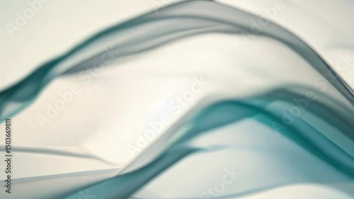 Translucent teal and blue fabric flowing gracefully creates serene, calming atmosphere with delicate textures and soft movement, evoking tranquility and elegance.