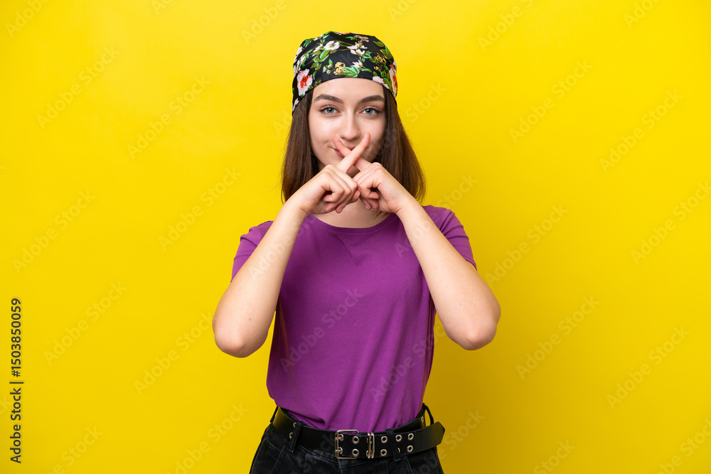 Young Ukrainian woman isolated on yellow background showing a sign of silence gesture Young Ukrainian woman isolated on yellow background showing a sign of silence gesture