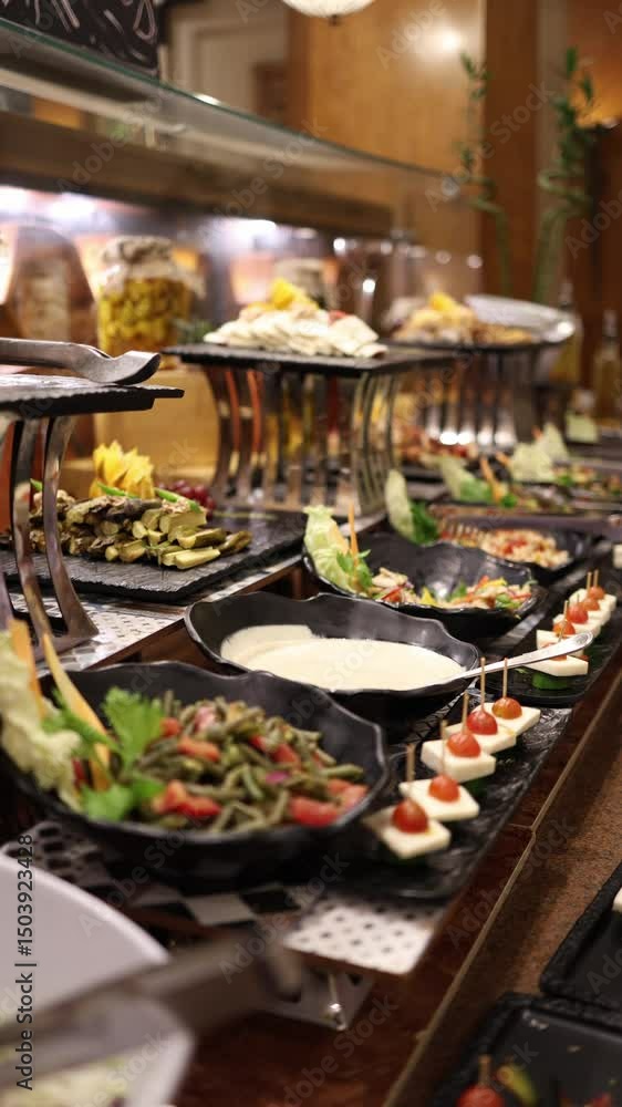 Vertical screen Gourmet salad bar with colorful appetizers dips and fresh vegetables neatly arranged on elegant black trays perfect for healthy choices and refined buffet dining Vertical screen Gourmet salad bar with colorful appetizers dips and fresh vegetables neatly arranged on elegant black trays perfect for healthy choices and refined buffet dining