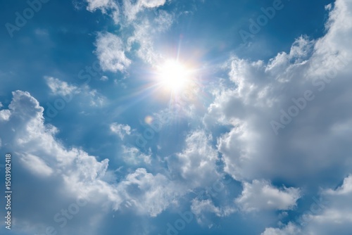 Bright Sun Shining Through Fluffy White Clouds in a Vivid Blue Sky