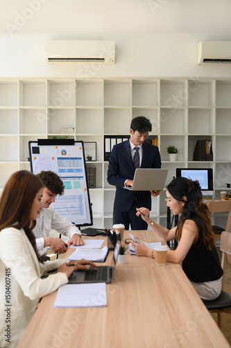 Diverse Business Team Collaborating During Office Presentation, Vertical image