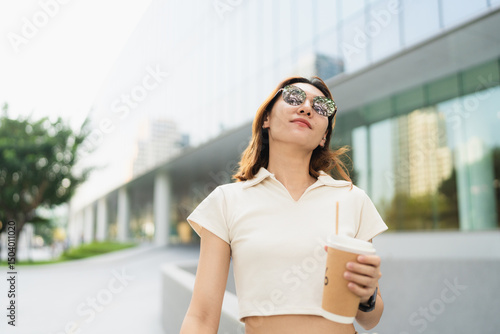 Business asian entrepreneur smart woman drink coffee on office building background