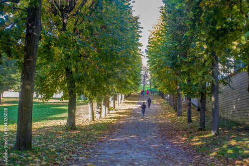 People running in Saint Claud  in autumn orange day in Paris