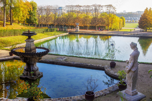 Pond nd statues  in Saint-Claude in autumn orange day in Paris.