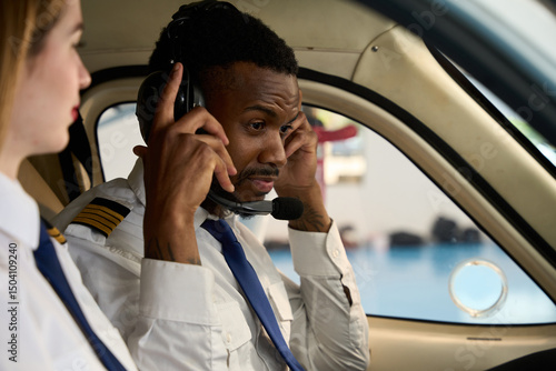 Papier peint Student pilot adjusting headset in cockpit with instructor beside him