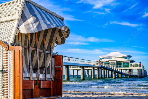 Fototapeta Naklejka Na Ścianę i Meble -  Beachside cabins lined on a sunny day showcasing vibrant colors and clear skies in a coastal location