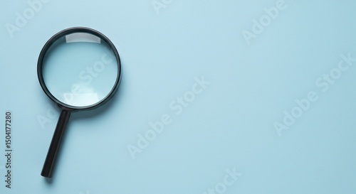 Wallpaper Mural Magnifying glass resting on a blue background used to find small details Torontodigital.ca